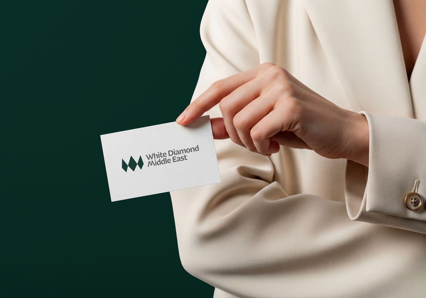 A White Diamond Middle East business card held in the hand.